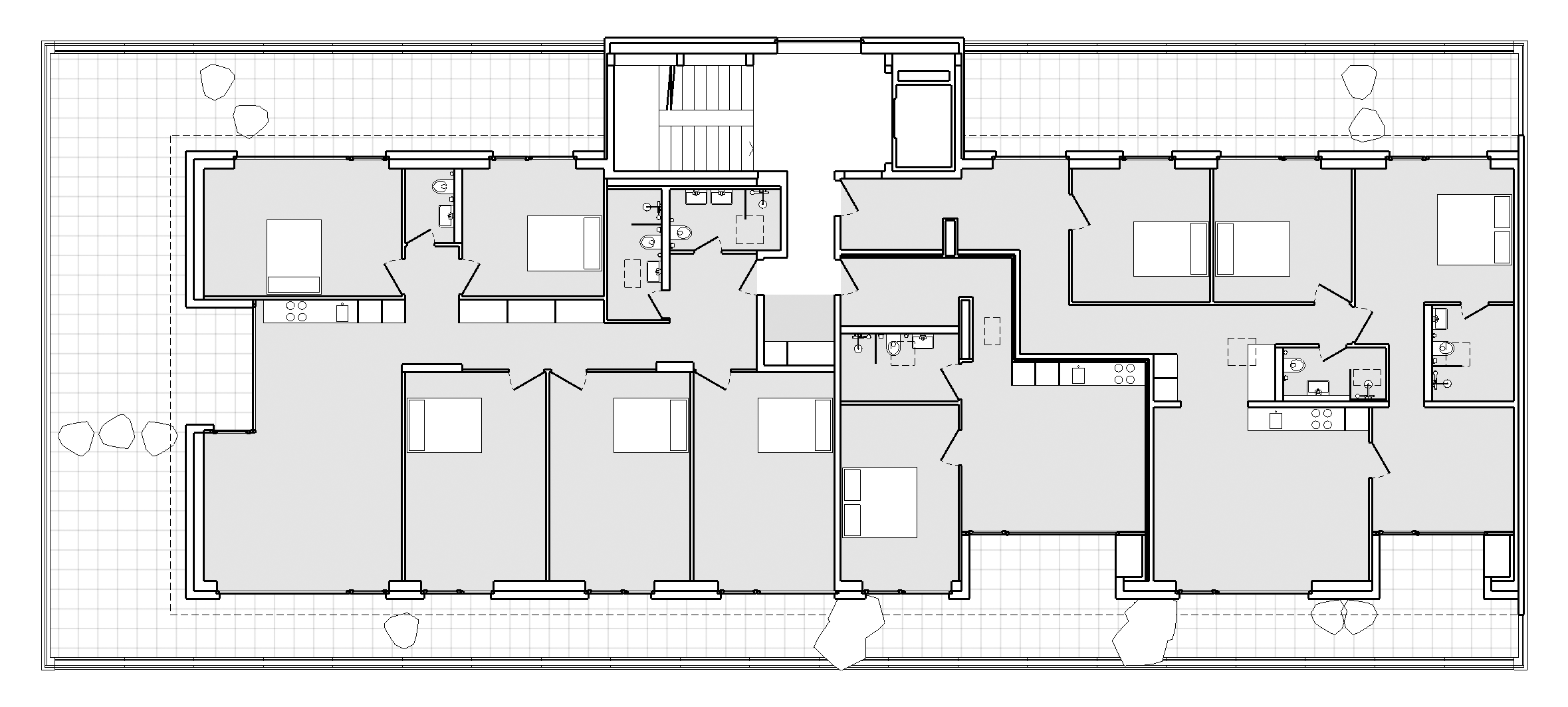  von KGRUPPE Architekten Basel - Grundriss eines Wohngebäudes mit mehreren Zimmern, Küchen und Badezimmern, verbunden durch einen zentralen Korridor.